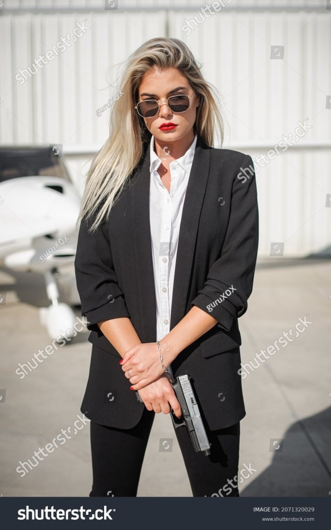 stock-photo-beautiful-professional-female-spy-agent-bodyguard-posing-with-gun-security-police-...jpg